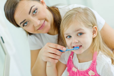 Mom and Daughter brushing their teeth - Pediatric Dentist in Springfield, MO
