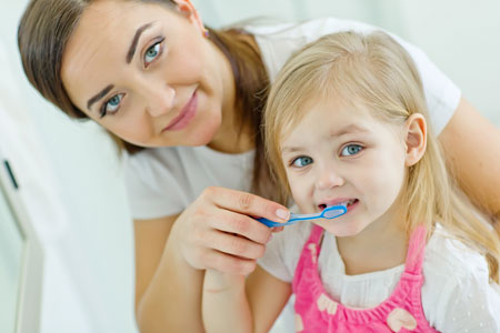 Mom and Daughter brushing their teeth - Pediatric Dentist in Springfield, MO